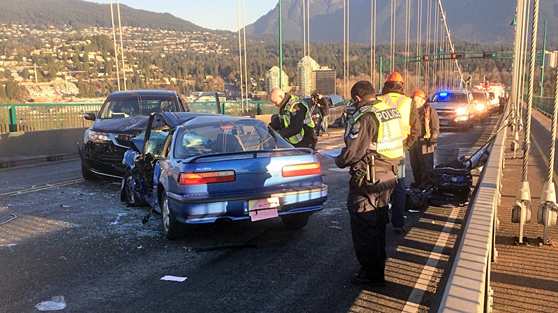 Emergency crews survey the damage after a head-on collision shut down traffic on the Lions Gate Bridge Tuesday morning, Dec. 3, 2013. (CTV)
