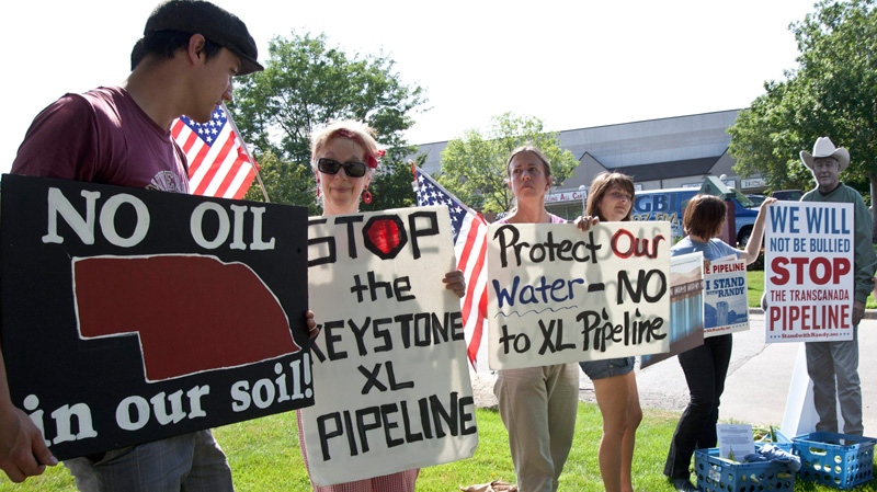 Protestors opposed to the Keystone XL pipeline hold signs outside the office of Rep. Lee Terry, R-Neb., in Omaha, Neb., Tuesday, July 26, 2011. (AP / Nati Harnik)