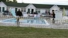 Emergency personnel probe the scene after a teen was found in an outdoor pool in Niagara Falls, Tuesday, July 26, 2011. 