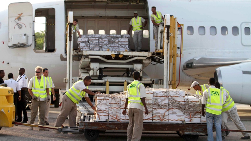 Some 10 tonnes of relief food from the World Food Programme (WFP) is unloaded after landing in Mogadishu airport, Wednesday, July 27, 2011. (AP / Feisal Omar)