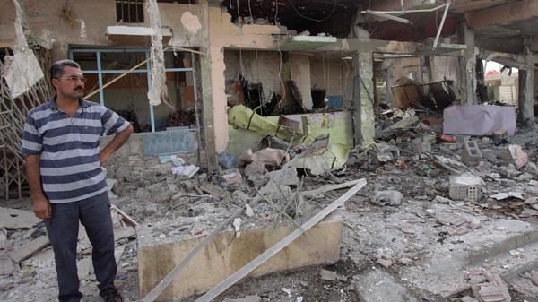 An Iraqi man inspects a destroyed liquor store after a bomb attack in Baghdad, Iraq, Thursday, July 28, 2011. (AP / Karim Kadim)