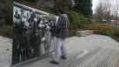 A man allegedly urinates on the Komagata Maru memorial in Vancouver's Coal Harbour on Dec. 2. (CTV)