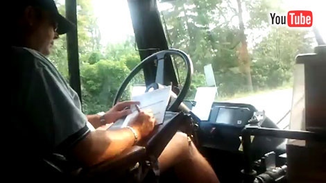An STO bus driver is captured in a YouTube video doing paperwork while driving the bus in Gatineau.