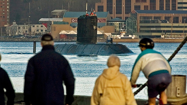 HMCS Windsor will be restricted in its ability to dive deep beneath the seas because of rust, according to a document obtained by The Canadian Press. People walk and cycle along a dock as HMCS Windsor prepares to dock in Halifax on Thursday, Dec. 21, 2006. (THE CANADIAN PRESS/Andrew Vaughan)