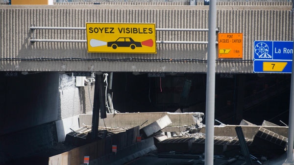 A section of an overpass is shown after it collapsed in Montreal Sunday, July 31, 2011. (Graham Hughes / THE CANADIAN PRESS)