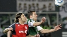Portland Timbers forward Kenny Cooper, right, and Toronto FC defender Torsten Frings chase down the ball during the second half of their MLS soccer game in Portland, Ore., Saturday, July 30, 2011. (AP Photo/Don Ryan)