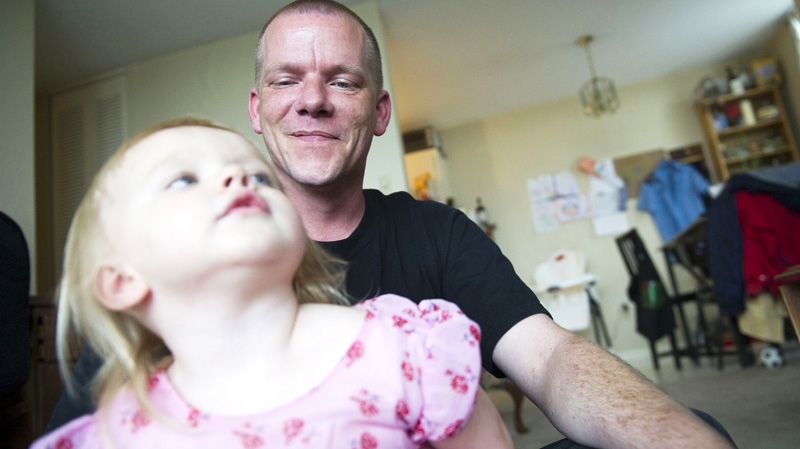Mark Shea plays with his daughter Christy, 2, in Edmonton, Alta. on Wednesday, July 6, 2011. (Ian Jackson / THE CANADIAN PRESS)