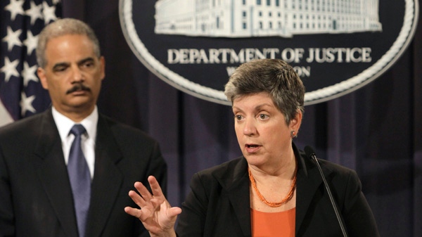 U.S. Attorney General Eric Holder listens at left as Homeland Security Secretary Janet Napolitano speaks at the Justice Department in Washington, Wednesday, Aug. 3, 2011. (AP / Jacquelyn Martin)