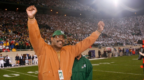 In this September 2006 photo provided by Michigan State University, former Michigan State football player Bubba Smith raises his arms during a ceremony at which his jersey number was retired, in East Lansing, Michigan. (Michigan State University)