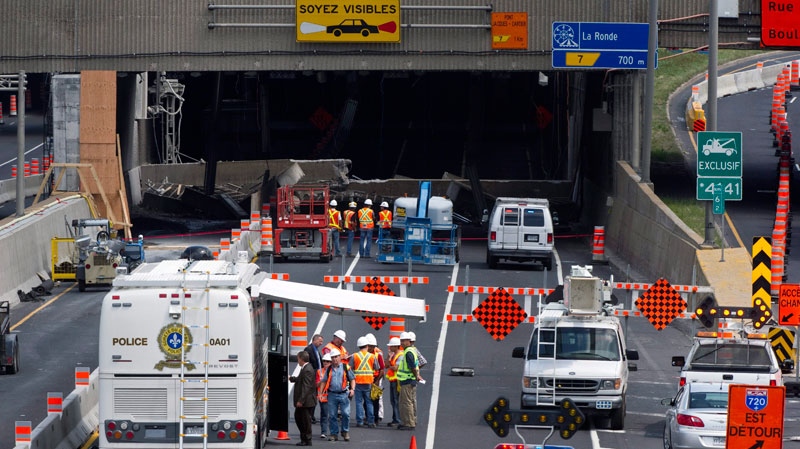 Engineers inspect a concrete slab that fell on a major expressway Monday, August 1, 2011 in Montreal. (Paul Chiasson / THE CANADIAN PRESS)