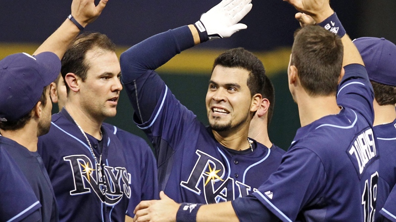 Tampa Bay Rays' Robinson Chirinos, center, is congratulated by teammates including Casey Kotchman, left, and Ben Zobrist after hitting the game-winning RBI single in the 12th inning of their 7-6 win over the Toronto Blue Jays in a baseball game Thursday, Aug. 4, 2011, in St. Petersburg, Fla. (AP Photo/Mike Carlson)