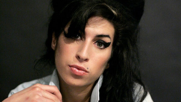 In this Friday Feb. 16, 2007 file photo British singer Amy Winehouse poses for photographs after being interviewed by the Associated Press at a studio in north London.  (AP / Matt Dunham, File)