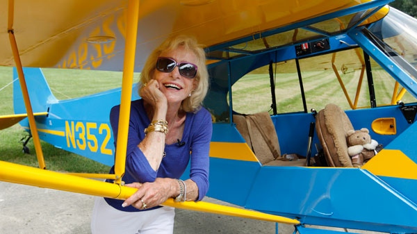 Myrtle Rose, 75, stands by her 1941 Piper J-3 Cub named 'Winston' on her property in South Barrington, Ill., Friday, Aug. 5, 2011. (AP / M. Spencer Green)