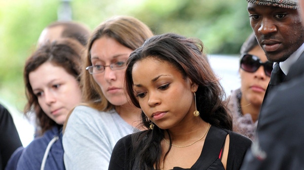 Singer Dionne Bromfield, goddaughter of Amy Winehouse, views tributes outside the late singer's north London home, Tuesday, July 26, 2011. (AP Photo)