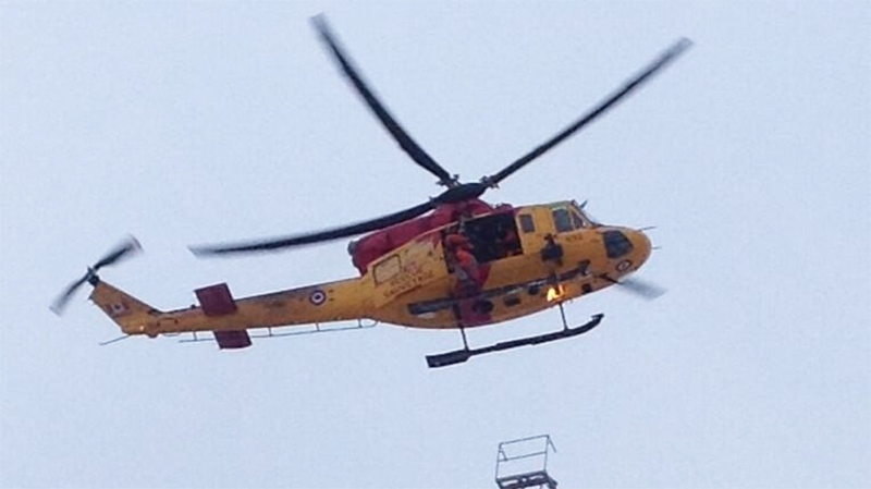 A helicopter heads to the scene of a massive fire in Kingston, Ont. on Tuesday, Dec. 17, 2013. (@barb888 / Twitter)
