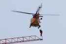 A search and rescue helicopter rescues a crane operator during a fire in downtown Kingston, Ont., on Dec.17, 2013. (Lars Hagberg / THE CANADIAN PRESS)