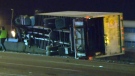 A truck lies on its side after crashing through a concrete barrier on Highway 401 early this morning.