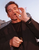 In this June 11, 1996 picture, Arnold Schwarzenegger lights up a cigar at the Mann's Chinese Theater in the Hollywood section of Los Angeles. (AP / Chris Pizzello)