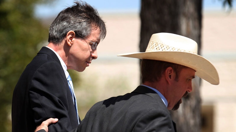 Warren Jeffs, leader of the Fundamentalist Church of Jesus Christ of Latter Day Saints, left, is led out of the Tom Green County Courthouse in San Angelo, Texas on Tuesday, Aug. 9, 2011. (AP / The San Angelo Standard-Times, Patrick Dove)