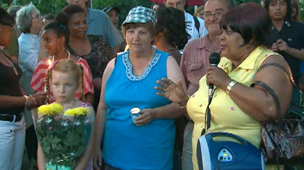 Charles McGillivary's mother Ann, centre, attends a vigil in honour of her son at Christie Pits Park on Monday, Aug. 8, 2011.
