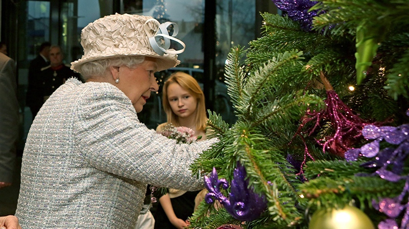 Queen Elizabeth II decorates a tree in London