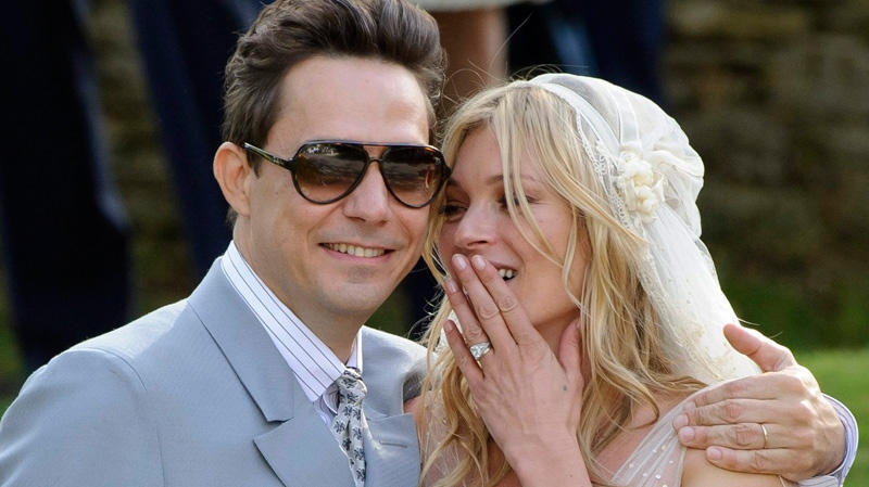 British model Kate Moss and British guitarist Jamie Hince pose for photographers, after their wedding in the village of Southrop, England, Friday, July 1, 2011. (AP / Jonathan Short)