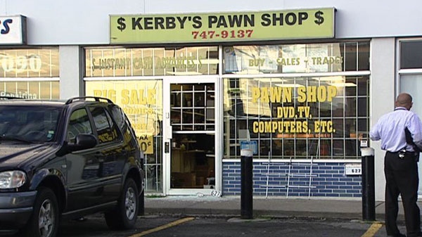 A suspect was arrested after an armed robbery at Kerby's Pawn Shop on Center Street in east Ottawa, Wednesday, Aug. 11, 2011. 