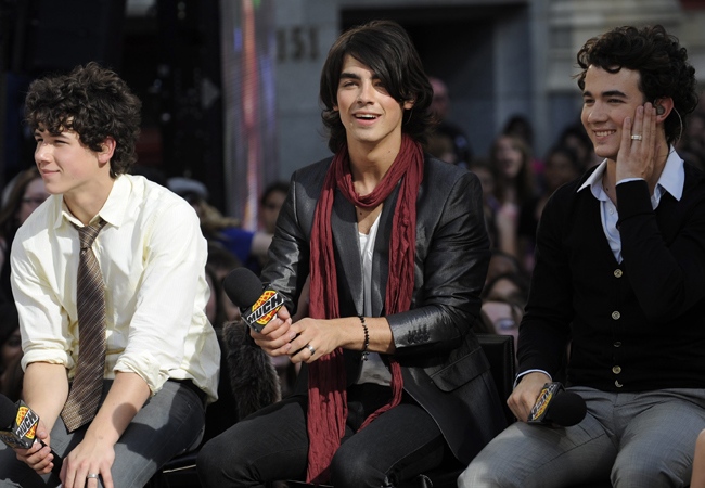 Jonas Brothers Nick, left, Joe, centre, and Kevin speak to fans during an appearance on Live@Much in Toronto on Thursday, July 3, 2008. (Aaron Harris / THE CANADIAN PRESS)  