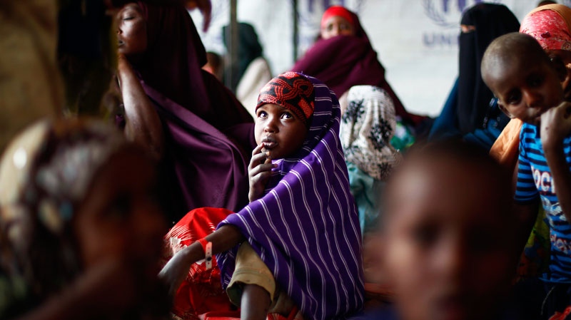 Somali refugees wait outside the UNHCR registration center in the Eastern Kenyan village of Hagadera near Dadaab, 100 kms (60 miles) from the Somali border, Friday Aug. 12, 2011.  (AP / Jerome Delay)