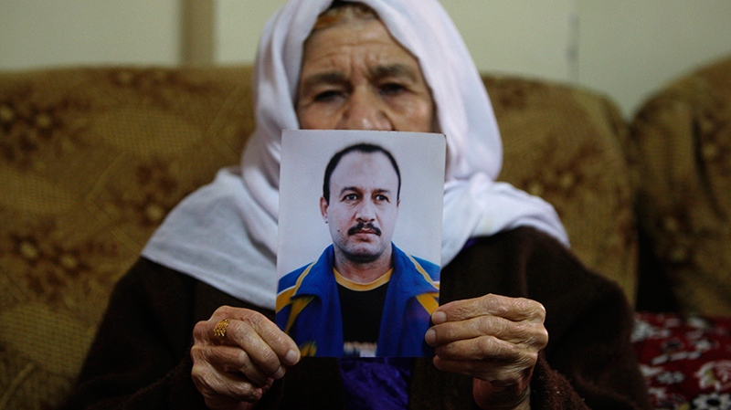 Palestinian Hassiba Shehadeh holds son's photo.