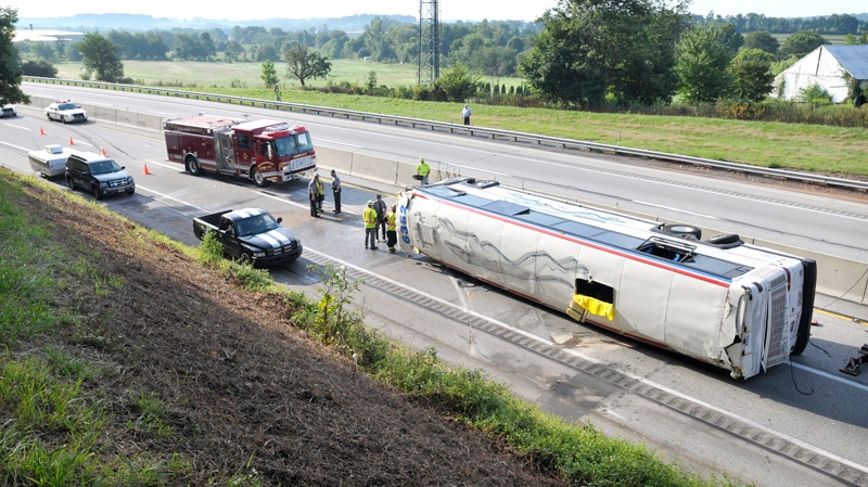 Emergency personnel work the scene where a Greyhound bus bound for St. Louis from New York City flipped on its side on the Pennsylvania Turnpike, about one mile east of the Lancaster-Lebanon interchange, near Manheim, Pa., Saturday, Aug. 13, 2011.  (AP / Lancaster Newspapers, Dan Marschka)