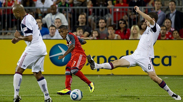 Toronto FC 's Joao Plata (centre) scores his team's winning goal as Real Salt Lake's Robbie Russell (left) and Will Johnson try to close in during second half MLS action in Toronto on Saturday August 13, 2011. (THE CANADIAN PRESS/Chris Young)