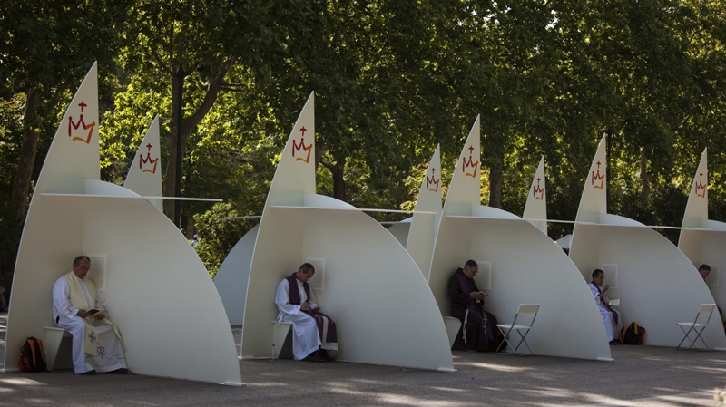 Priests are seen inside their temporary confession boxes as they wait for worshipers in the Retiro park ahead to the visit of Pope Benedict XVI in Madrid on Wednesday Aug. 17, 2011. (AP / Emilio Morenatti) 