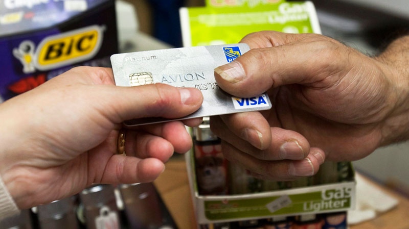 A consumer pays with a credit card at a store Tuesday, July 6, 2010 in Montreal. Ryan Remiorz / THE CANADIAN PRESS