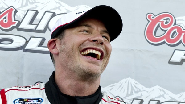 Canada's Jacques Villeneuve smiles after taking the pole position during qualifying session at the NAPA Auto Parts 200 NASCAR Nationwide race Friday, August 19, 2011 in Montreal. THE CANADIAN PRESS/Paul Chiasson