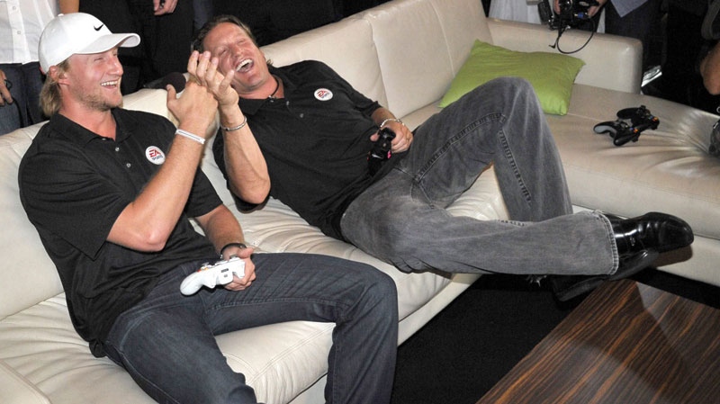 Steven Stamkos and Jeremy Roenick celebrate a goal while playing EA Sports NHL 12 during an exclusive Xbox holiday preview event in Toronto, Thursday, Aug. 18, 2011. (Xbox Canada) 