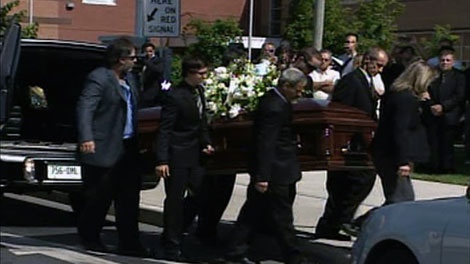 A single casket is carried into an Alexandria church, Friday, Aug. 19, 2011. 
