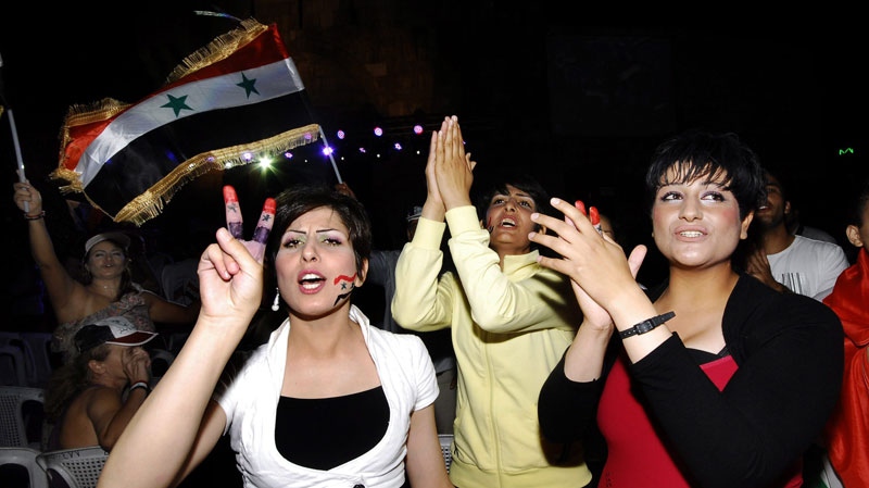 Supporters of Syrian President Bashar Assad shout slogans and wave their national flag, as they protest to show their solidarity to their president, in Damascus, Syria, on Friday Aug. 19, 2011. (AP / Muzaffar Salman)