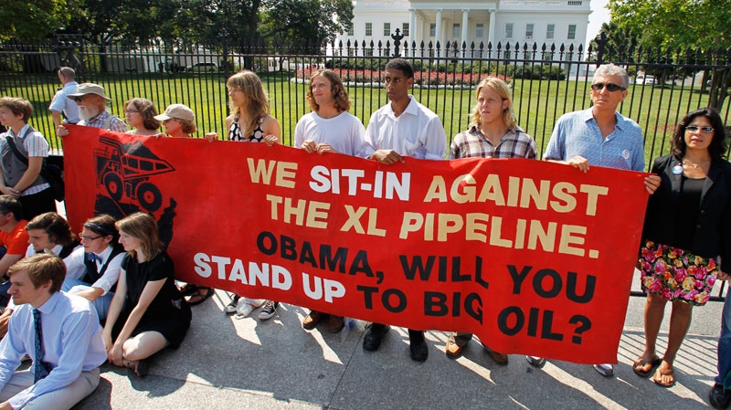Protesters over a proposed pipeline to bring tar sands oil to the U.S. from Canada, gather in front of the White House in Washington, Saturday, Aug. 20, 2011. (AP / Manuel Balce Ceneta)