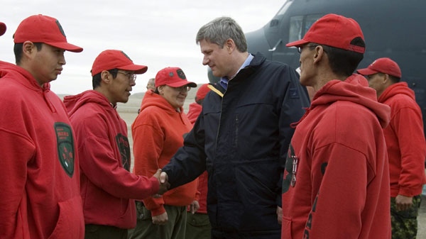 Prime Minister Stephen Harper is greeted by Arctic Rangers as he arrives in Resolute Bay, Nunavut, Friday August 10, 2007. The fatal crash of a jetliner in Resolute Bay on Saturday has cast a pall over Harper's annual Arctic tour scheduled for this week. THE CANADIAN PRESS/Fred Chartrand)