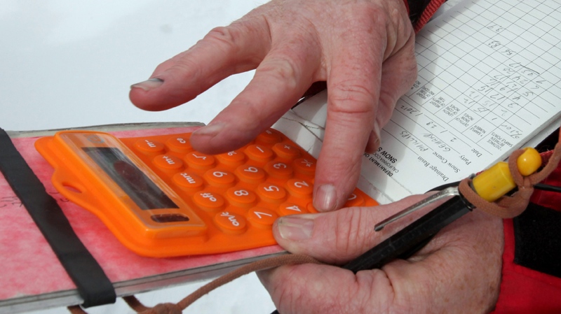 Frank Gehrke uses a calculator