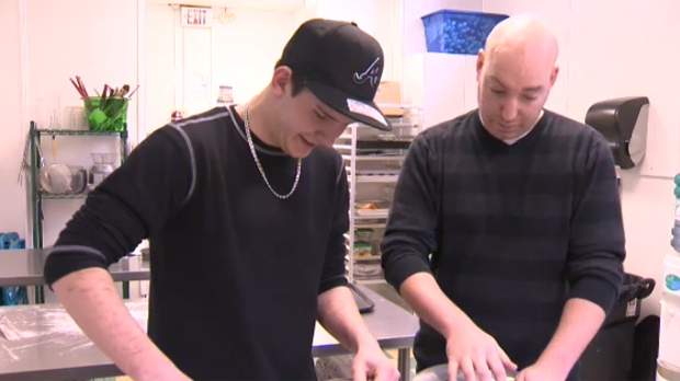 Michael Johnson and Paul Graesser work side by side in the kitchen as part of the Roofs for Youth program