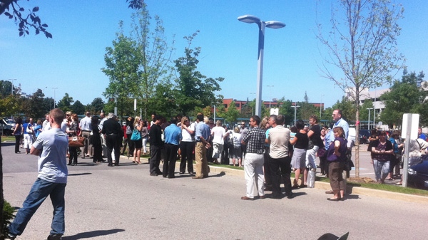 office workers are evacuated after a magnitude 5.9 earthquake is felt in Markham, Ont., on Tuesday, Aug. 23, 2011. (Aimee Jessop for CTV News)