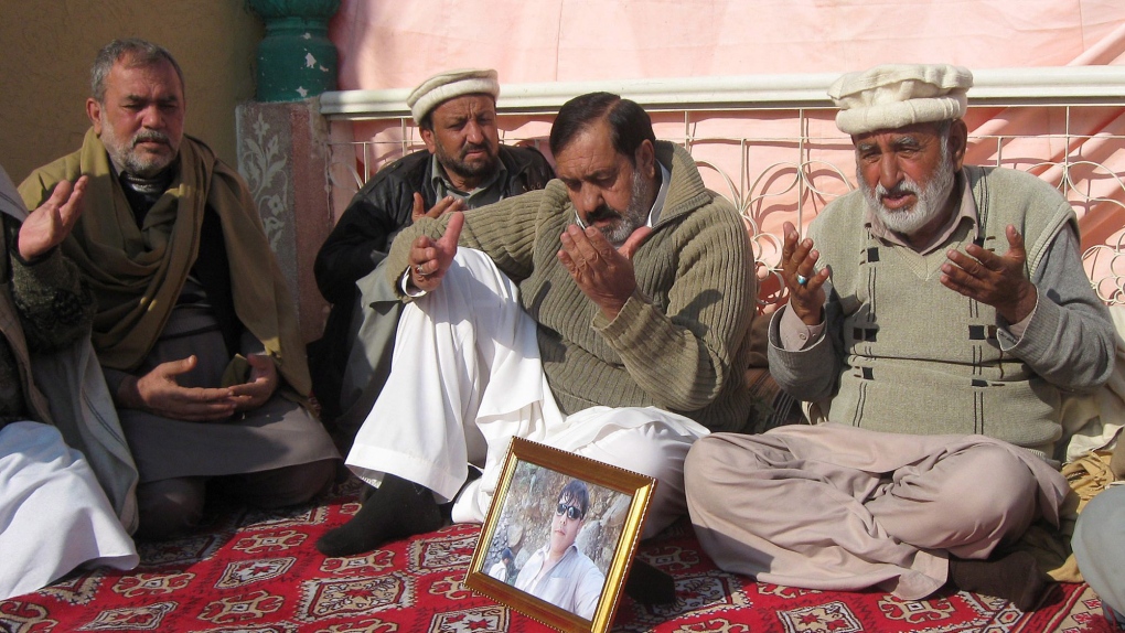 Pakistani villagers pray for Aitzaz Hasan