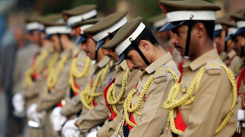 Yemeni honor guards stand in a line during the funeral procession of Chairman of the Shura Council Abdul Aziz Abdul Ghani, who died of injuries sustained in the June 3, 2011 attack on Yemeni President Ali Abdullah Saleh's compound, in Sanaa, Yemen, Wednesday, Aug. 24, 2011.(AP / Hani Mohammed)
