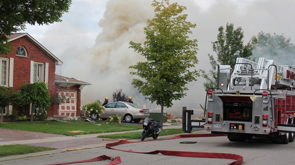 Firefighters are shown at the scene of a house explosion that reportedly damaged other homes in the vicinity in Brantford, Ont., on Thursday, August 25, 2011.