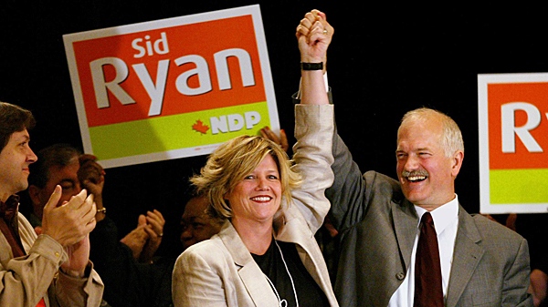 Federal NDP leader Jack Layton holds the hand of then-newly-elected Hamilton East MPP Andrea Horwath at the CUPE Ontario convention in Toronto on Saturday, May 29, 2004. (CP PHOTO/Andrew Vaughan)