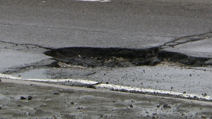 A deep pothole in the middle of a road in Toronto, Monday, Jan. 13, 2014.