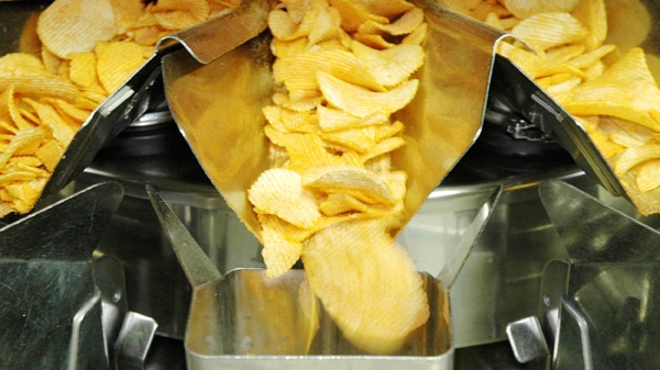 Potato Chips fall down chutes toward a bagging machine. (AP / Jay Reeves)