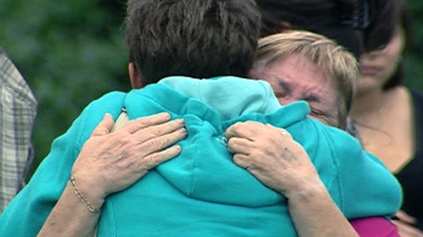 Valerie Leblanc's grandmother receives a hug at a vigil for her granddaughter, Wednesday, Aug. 24, 2011. 
